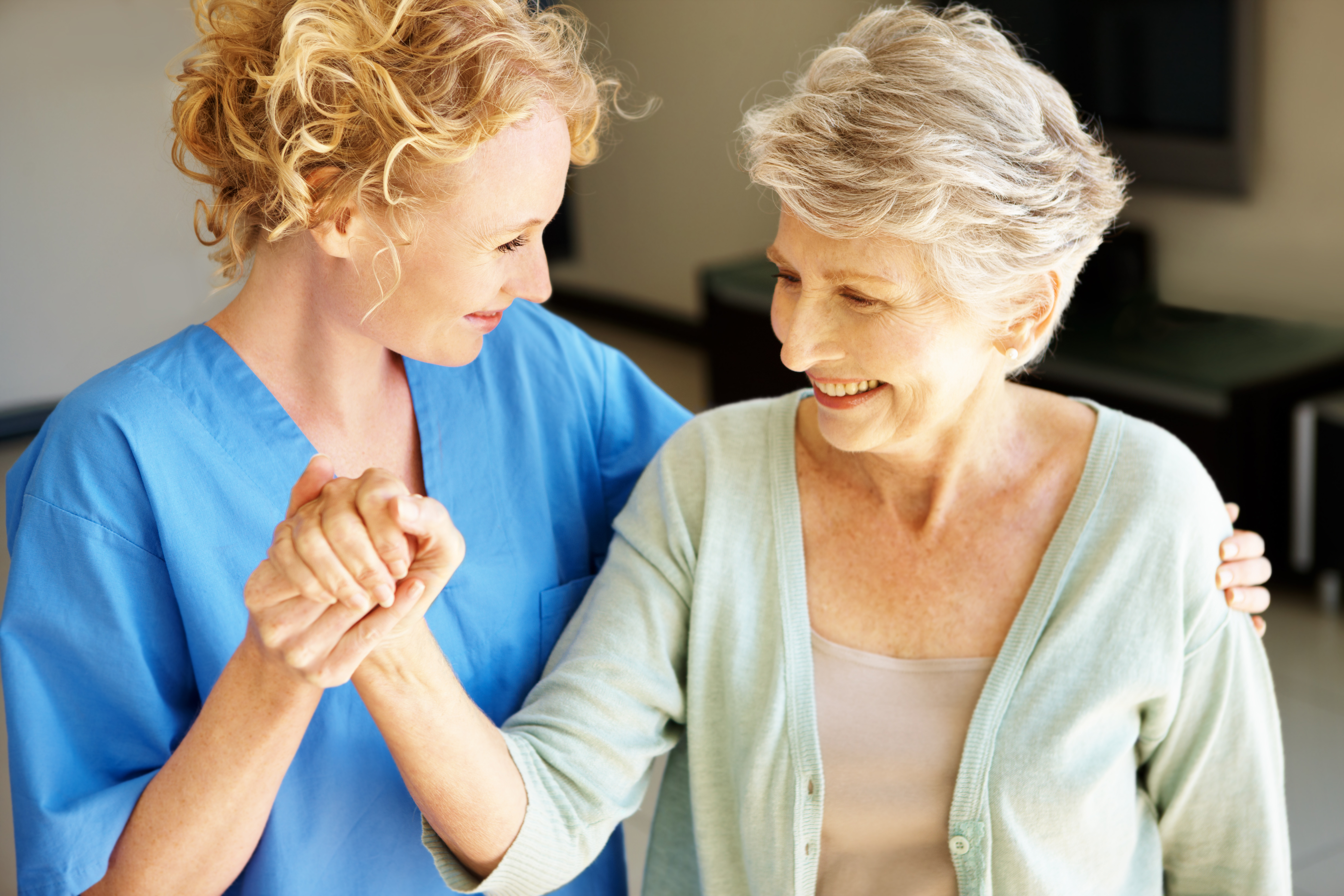 "Let's go get some fresh air!" - Senior Rehabilitation A young nurse helping her female senior patient go for a walk