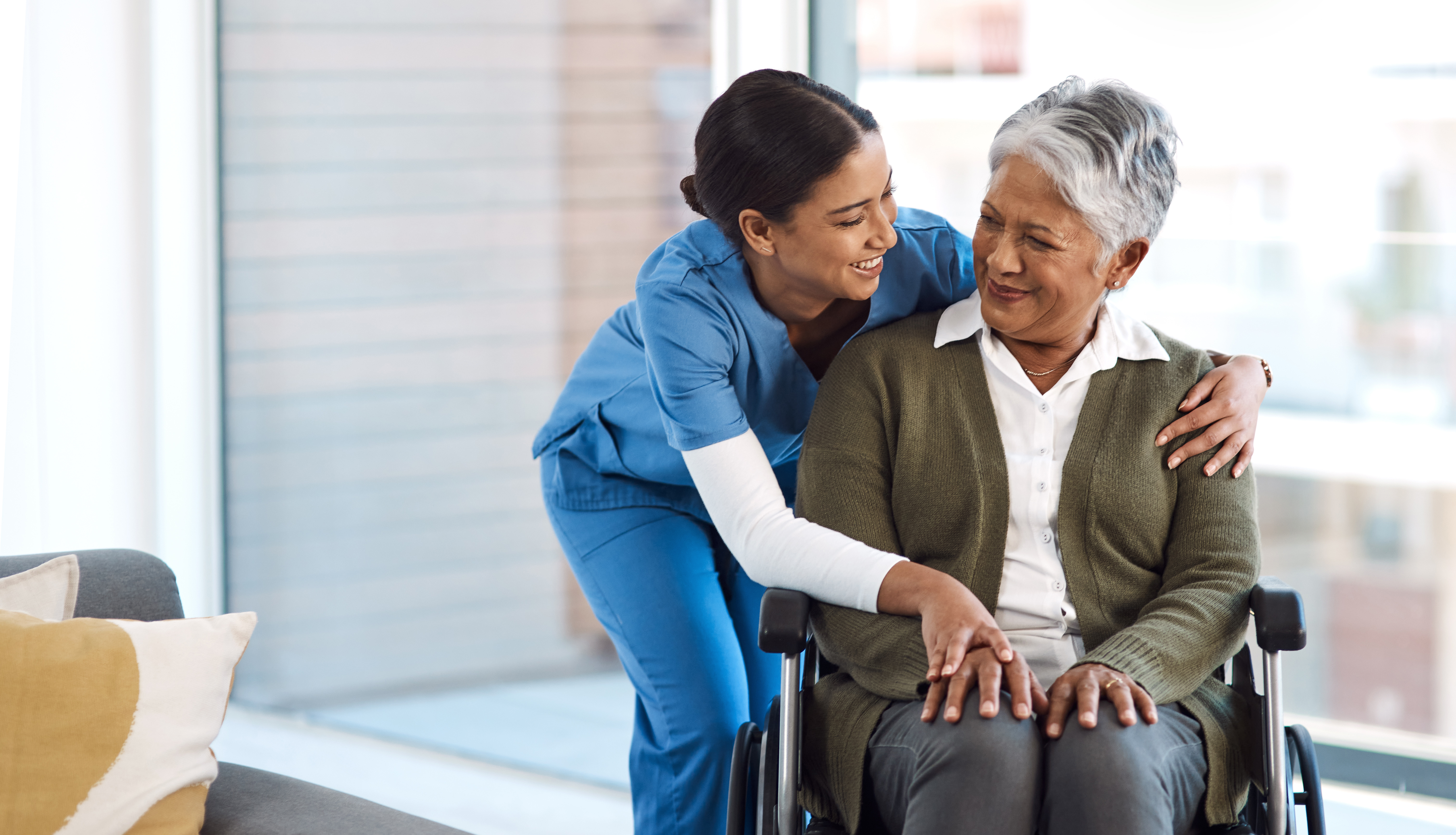 Cropped shot of an attractive young female nurse with a senior wheelchair-bound patient I'm glad you're doing okay