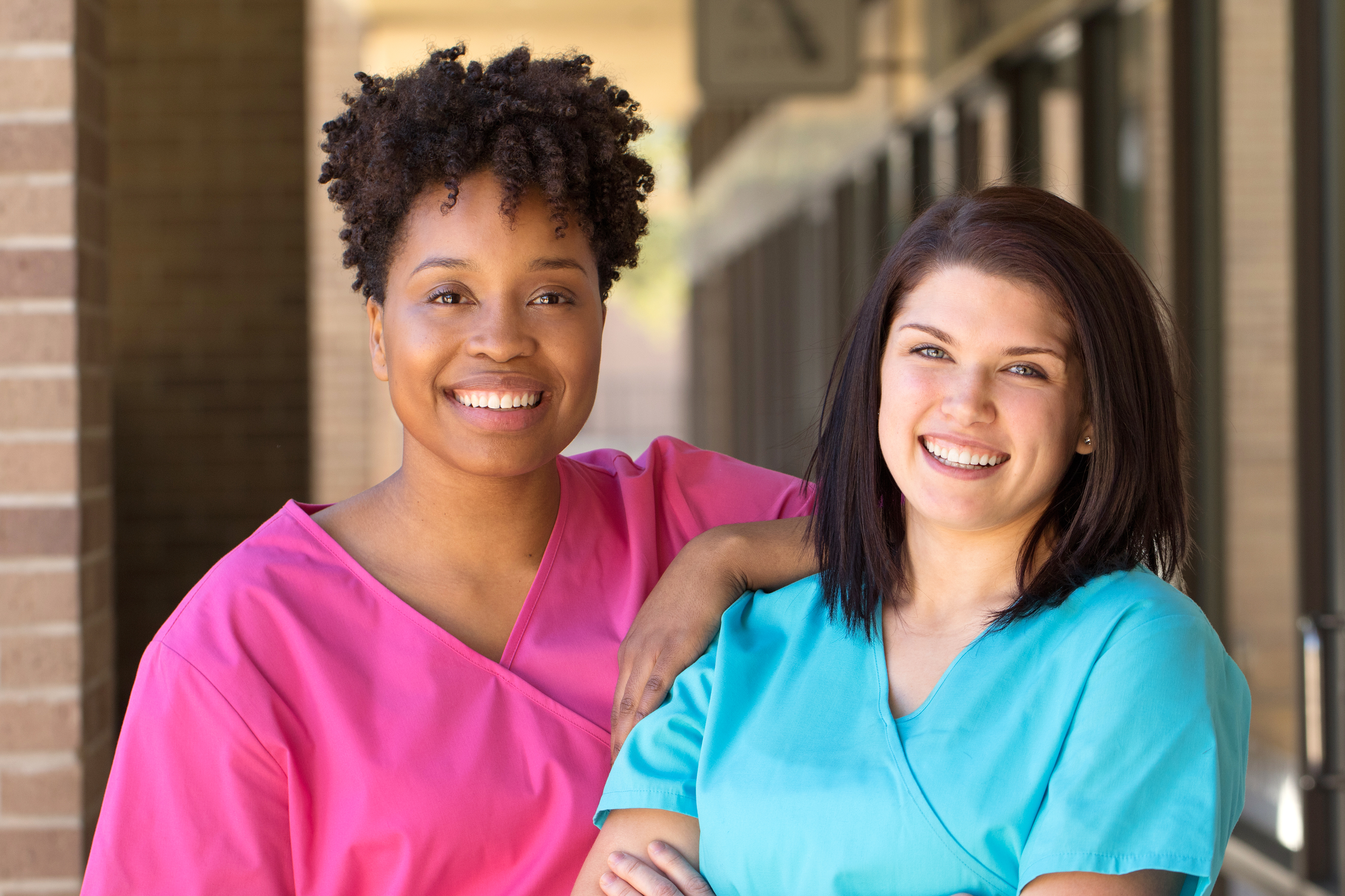 African American woman smiling Happy African American woman standing outside of a business or college.